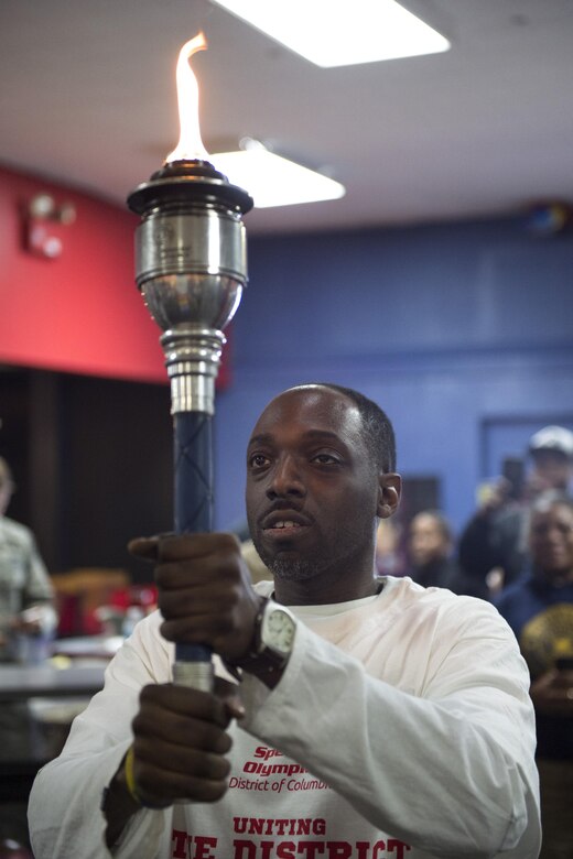 John Bossard, District of Columbia Special Olympics athlete, holds the opening ceremony flame before kicking off the 2017 D.C. Special Olympics Bowling Championship at Hyattsville, Md., Feb. 16, 2017. Opening ceremonies also included the national anthem and presenting of the colors by a U.S. Navy color team. (U.S. Air Force photo by Senior Airman Philip Bryant)