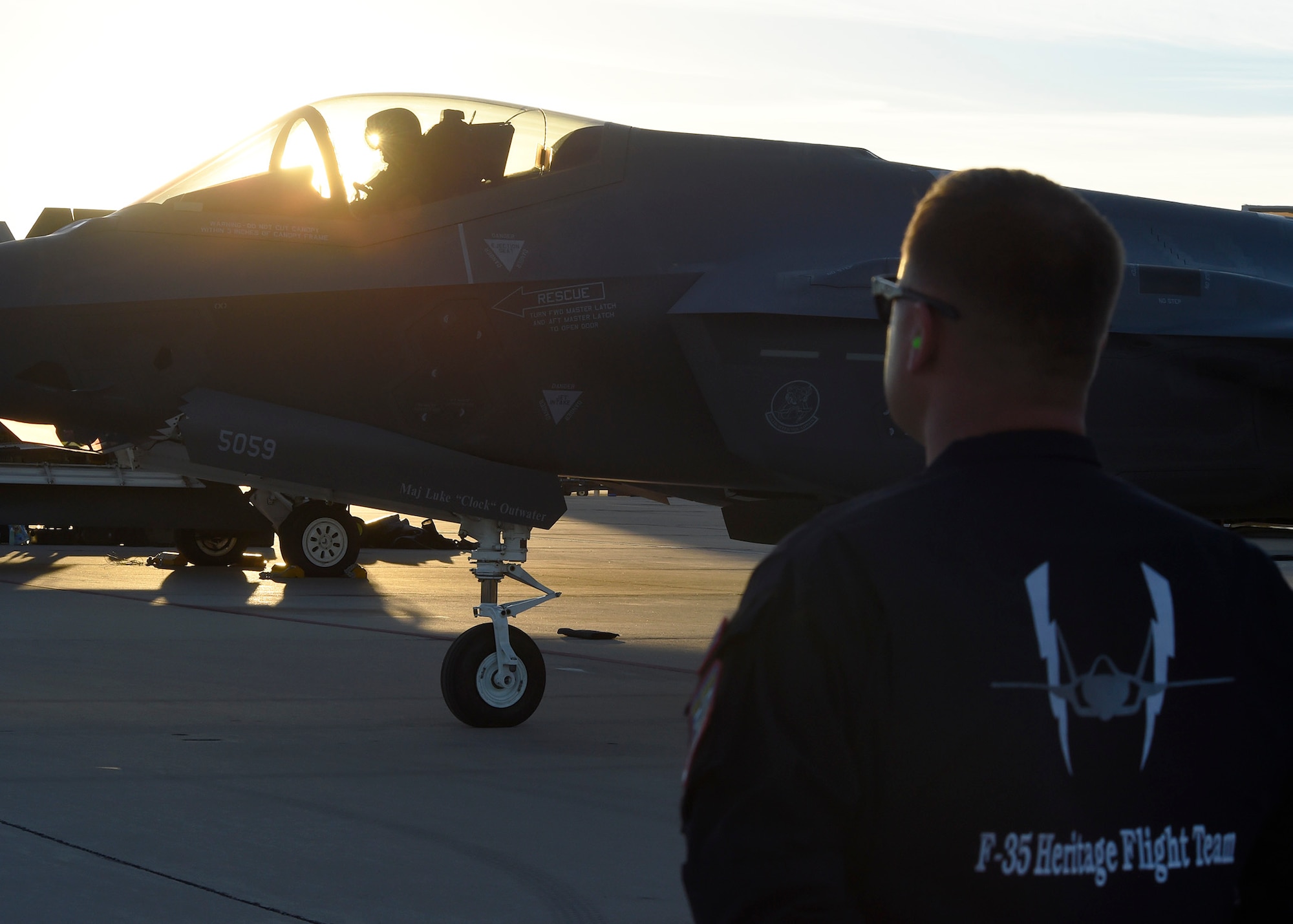 Senior Master Sgt. Sam Smith, 61st Fighter Squadron F-35 heritage flight superintendent, stands by for Maj. Will Andreotta, 61st FS heritage flight pilot, to get out of his jet after flying during the Heritage Flight Training and Certification Course Feb. 10, 2017, at Davis-Monthan Air Force Base, Ariz. Heritage and demonstration teams need to be certified annually to participate in open houses and air shows worldwide. (U.S. Air Force photo by Senior Airman James Hensley)  