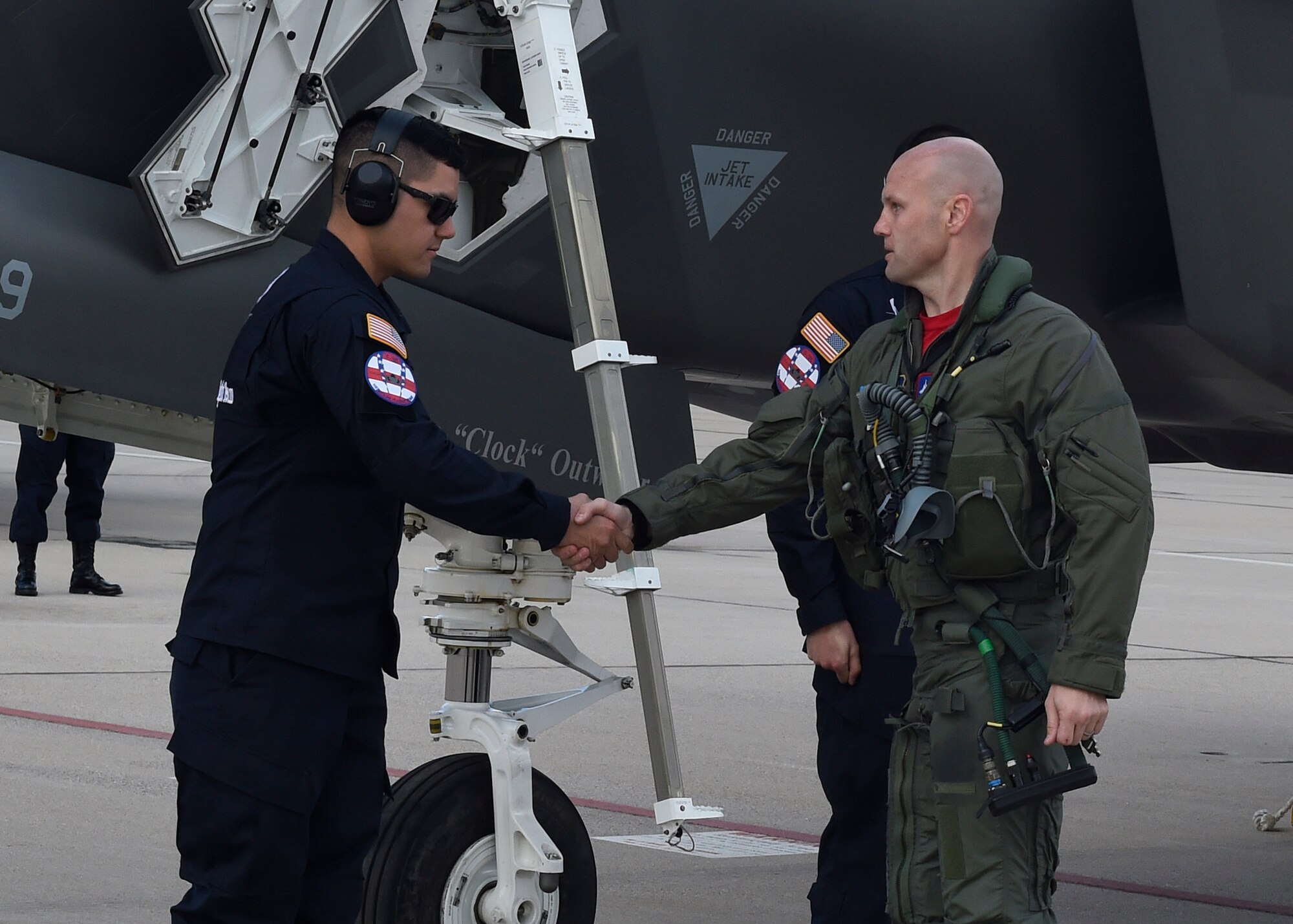Maj. Will Andreotta, 61st Fighter Squadron heritage flight pilot, shakes hands with Staff Sgt. Jeremy Miller, 61st FS heritage flight team avionics, prior to flying during the Heritage Flight Training and Certification Course Feb. 12, 2017, at Davis-Monthan Air Force Base, Ariz. Heritage and demonstration teams need to be certified annually to participate in open houses and air shows worldwide. (U.S. Air Force photo by Senior Airman James Hensley)   