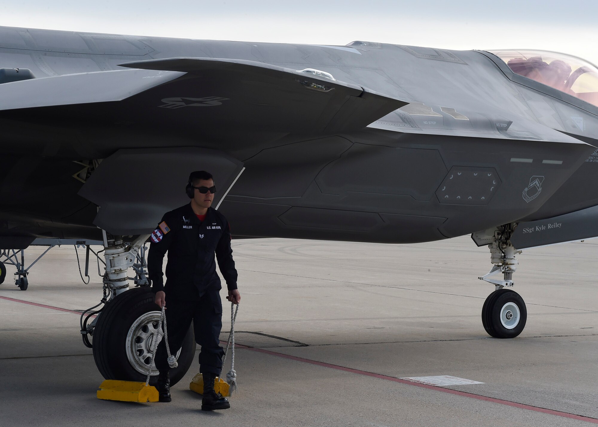 Staff Sgt. Jeremy Miller, 61st Fighter Squadron heritage flight team avionics, pulls chalks from the wheel of an F-35 Lightning II during the Heritage Flight Training and Certification Course Feb. 12, 2017, at Davis-Monthan Air Force Base, Ariz. Heritage and demonstration teams need to be certified annually to participate in open houses and air shows worldwide. (U.S. Air Force photo by Senior Airman James Hensley)   