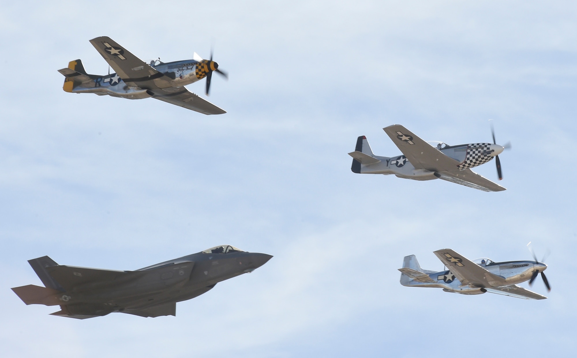 An F-35 Lightning II flies in formation with P-51 Mustangs during the Heritage Flight Training and Certification Course Feb. 9, 2017, at Davis-Monthan Air Force Base, Ariz. Heritage and demonstration teams need to be certified annually to participate in open houses and air shows worldwide. (U.S. Air Force photo by Senior Airman James Hensley)   