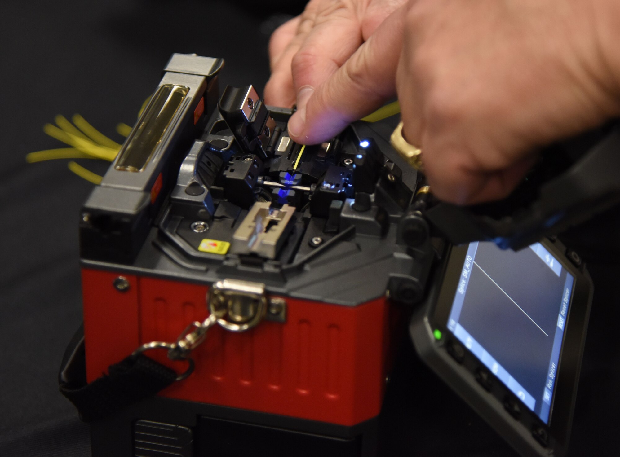 John DeMetro, FIS sales associate, provides a demonstration on fiber optic cable splicing during the 22nd annual Technology Expo at the Roberts Consolidated Aircraft Maintenance Facility Feb. 14, 2017, on Keesler Air Force Base, Miss. The 81st Communications Squadron hosted the free event open to all Defense Department, government and contractor personnel with base access. (U.S. Air Force photo by Kemberly Groue)