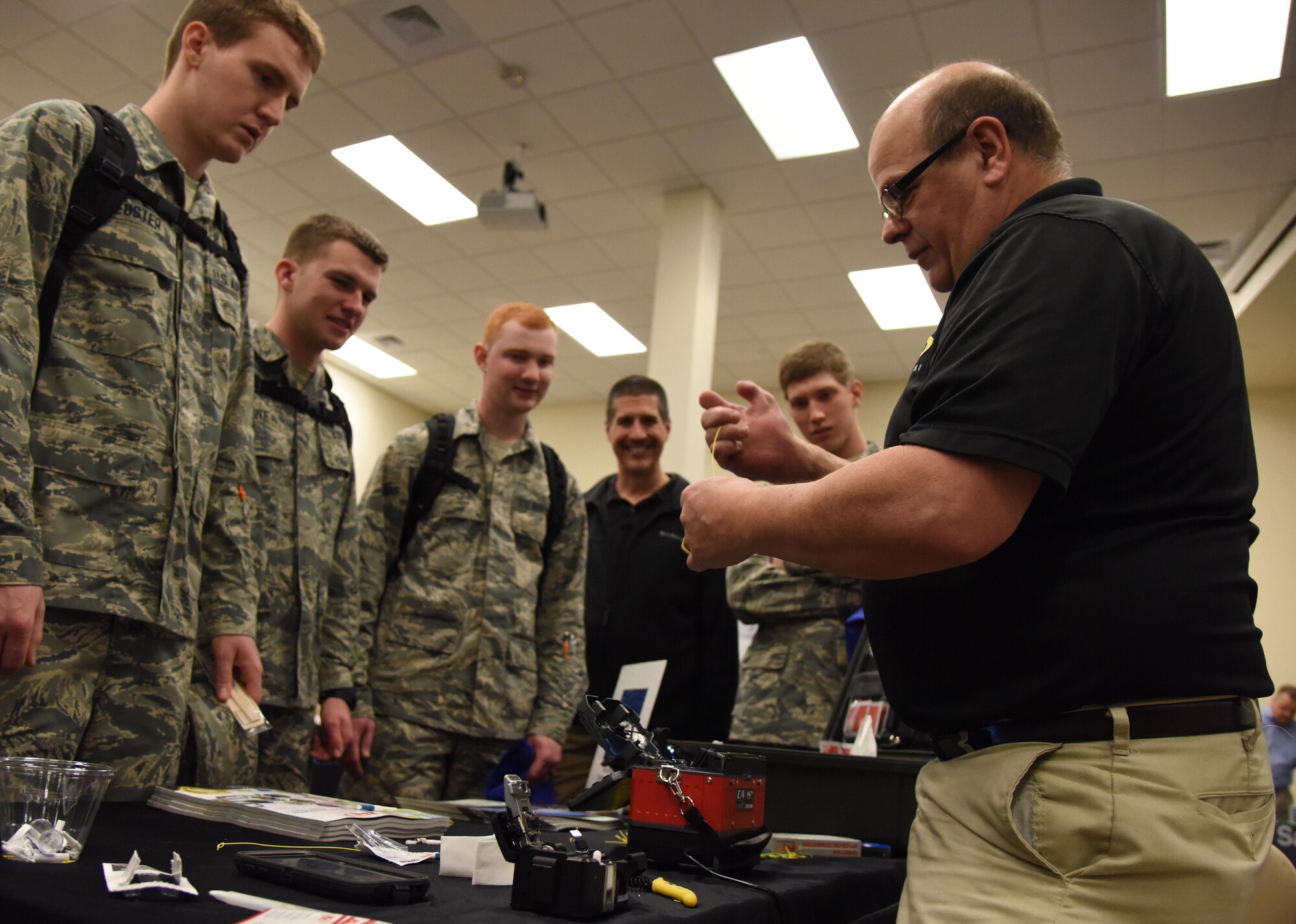 John DeMetro, FIS sales associate, provides a demonstration on fiber optic cable splicing during the 22nd annual Technology Expo at the Roberts Consolidated Aircraft Maintenance Facility Feb. 14, 2017, on Keesler Air Force Base, Miss. The 81st Communications Squadron hosted the free event open to all Defense Department, government and contractor personnel with base access. (U.S. Air Force photo by Kemberly Groue)
