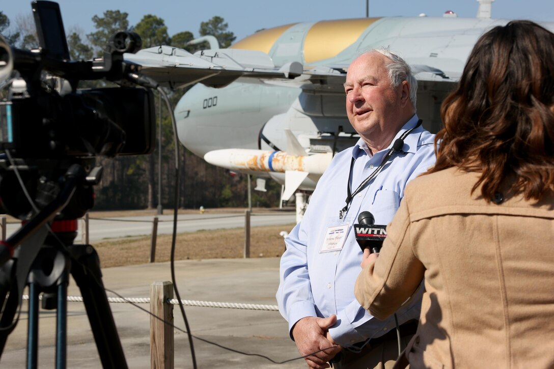 Col. (Ret.) Wayne Whitten, a member of the Marine Corps Aviation Reconnaissance Association, is interviewed by a reporter during the 40th anniversary commemoration ceremony held aboard Marine Corps Air Station Cherry Point, N.C., Feb. 17, 2017. The primary mission of the EA-6B Prowler is suppression of enemy air defenses in support of strike aircraft and ground troops by interrupting enemy electronic activity and obtaining tactical electronic intelligence within the combat area. (U.S. Marine Corps photo by Cpl. Jason Jimenez/ Released)