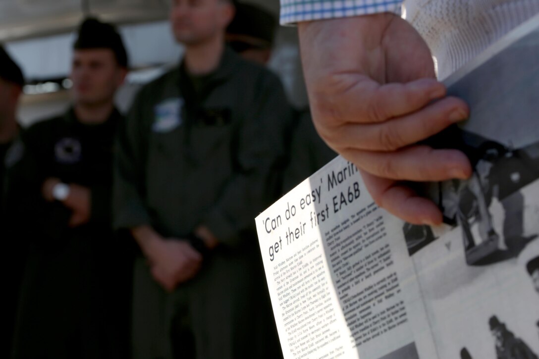 An attendee holds a copy of a news article depicting the arrival of the first EA-6B Prowler into the Marine Corps during a 40th anniversary commemoration ceremony held aboard Marine Corps Air Station Cherry Point, N.C., Feb. 17, 2017. The Prowler provides an umbrella of protection for strike aircraft, ground troops and ships by jamming enemy radar, electronic data links and communications. The Marine Corps is transitioning from the Prowler to the F-35B Lightning II. (U.S. Marine Corps photo by Cpl. Jason Jimenez/ Released)