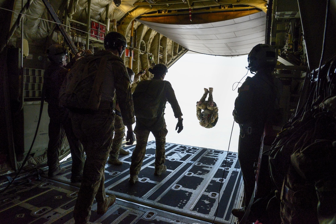 An airman somersaults from a C-130J Super Hercules during a free fall jump with Indian paratroopers as part of the Aero India 2017 exercise at Air Force Station Yelahanka in Bengaluru, India, Feb. 16, 2017. The U.S. participates in air shows to demonstrate its commitment to the security of the Indo-Asia-Pacific region. The airman is a combat controller assigned to the 353rd Special Operations Group. Air Force photo by Capt. Mark Lazane