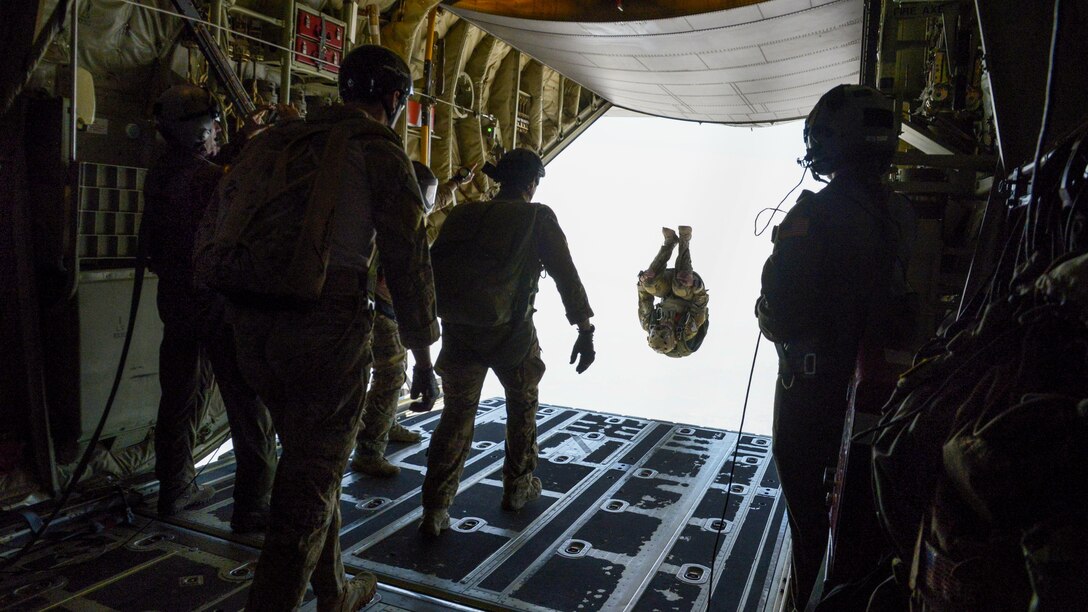 An airman somersaults from a C-130J Super Hercules during a free fall jump with Indian paratroopers as part of the Aero India 2017 exercise at Air Force Station Yelahanka in Bengaluru, India, Feb. 16, 2017. The U.S. participates in air shows to demonstrate its commitment to the security of the Indo-Asia-Pacific region. The airman is a combat controller assigned to the 353rd Special Operations Group. Air Force photo by Capt. Mark Lazane

