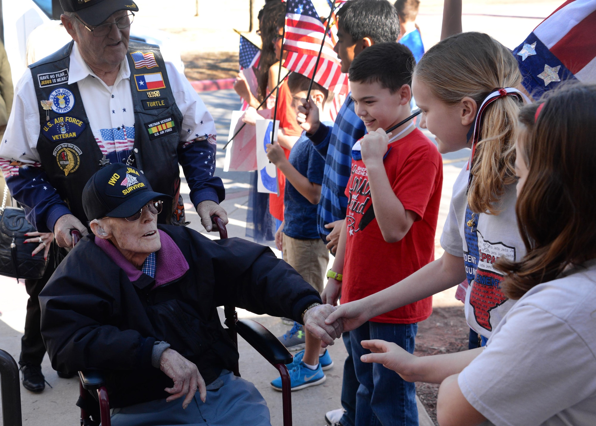 Iwo Jima survivors are greeted by children on Sheppard Air Force Base, Texas, Feb. 17, 2017. Children from Sheppard Elementary School met with WWII veterans during the Iwo Jima survivors 72nd Reunion. (U.S. Air Force photo by Senior Airman Robert L. McIlrath/Released)