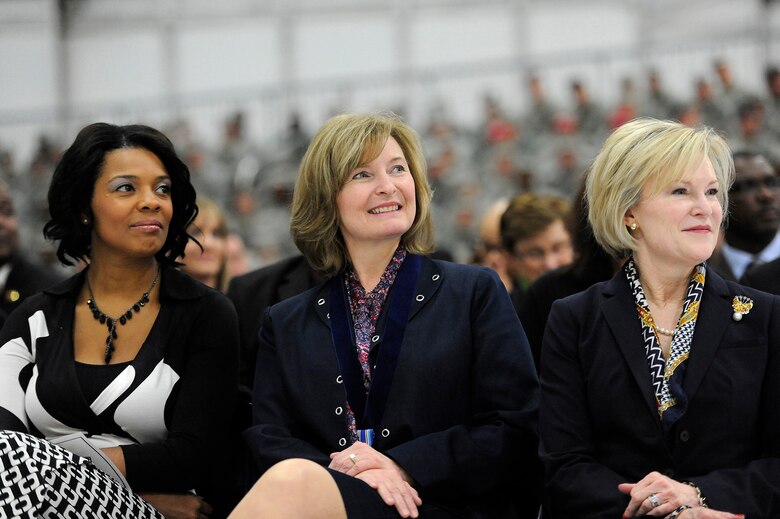 Athena Cody, center, smiles while her husband, Chief Master Sgt. of the Air Force James A. Cody, retires during a retirement and appointment ceremony on Joint Base Andrews, Md., Feb. 17, 2017. Cody retires after 32 years of service and is succeeded by Chief Master Sgt. of the Air Force Kaleth O. Wright, the 18th Airman to hold this position. With Athena Cody are Tonya Wright, right, wife of Chief Master Sgt. of the Air Force Kaleth O. Wright, and Dawn Goldfein, left, wife of Air Force Chief of Staff David L. Goldfein.  (U.S. Air Force photo/Tech. Sgt. Robert Barnett)
