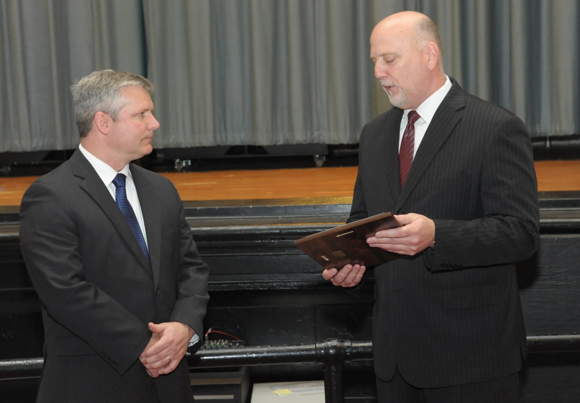 John Fedrico (R) deputy assistant Secretary of the Air Force for Reserve Affairs and Airman Readiness presents a letter of thanks to retired Air Force Lt. Col. Todd Ernst (L), during a ceremony on Feb. 13 at Joint Base San Antonio-Randolph, Texas. The letter, from Daniel Sitterly, principal deputy assistant to the Secretary of the Air Force for Manpower and Reserve Affairs, applauds Ernst’s contribution to helping ensure families of Reserve and Guard service members receive the same survivor benefits as active duty service members. (Air Force photo by Joel Martinez, Joint Base San Antonio-Randolph Public Affairs)