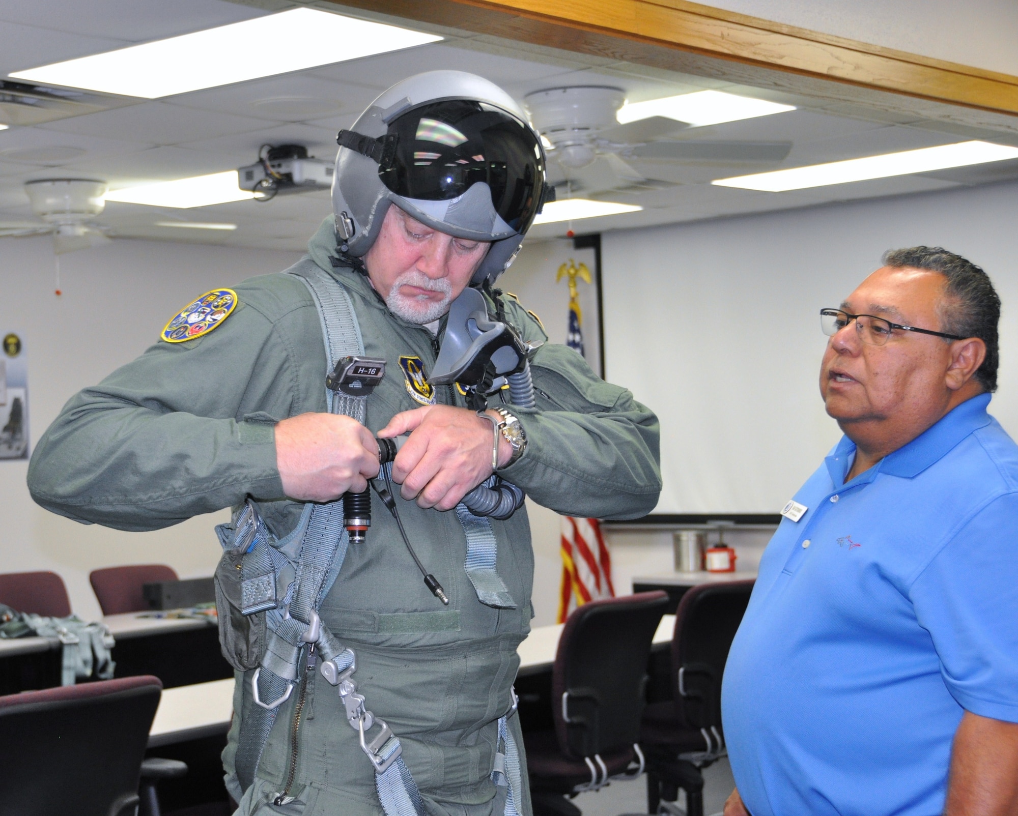 Ray Gutierrez, flight equipment life support technicians with the 559 Flying Squadron at Joint Base San Antonio-Randolph, Texas, makes final G-suit adjustments for John Fedrico, deputy assistant Secretary of the Air Force for  Reserve Affairs and Airman Readiness in preparation for a T-6 orientation flight here Feb. 13. Fedrico’s visit, hosted by the 340 FTG, served a dual purpose. Fedrico presented a letter of thanks to one of the unit’s own, retired Air Force Lt. Col. Todd Ernst. Ernst was honored for his efforts to help ensure families of Reserve and Guard service members receive the same survivor benefits as active duty service members. Fedrico also received a mission brief and got to experience the unit’s operations first hand. (Air Force photo by Janis El Shabazz, 340 FTG Public Affairs)