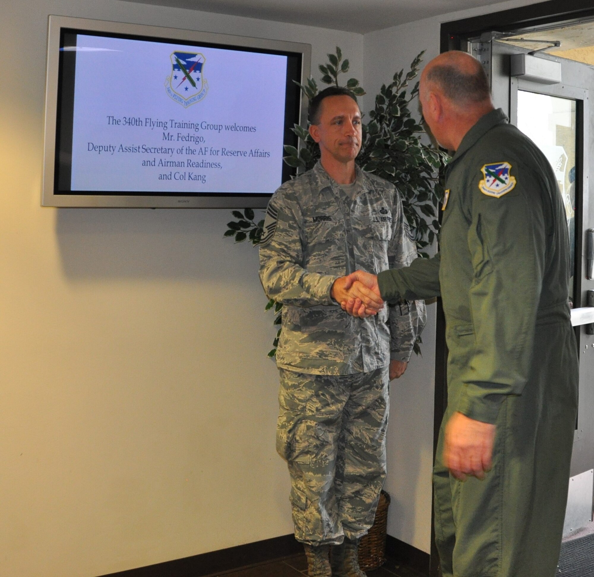 340th Flying Training Group Superintendent, Chief Master Sgt. Jimmie Morris, greets John Fedrico, deputy assistant Secretary of the Air Force for  Reserve Affairs and Airman Readiness, during his visit here Feb. 13. Fedrico presented a letter of thanks to one of the unit’s own, retired Air Force Lt. Col. Todd Ernst. Ernst was honored for his efforts to help ensure families of Reserve and Guard service members receive the same survivor benefits as active duty service members. Fedrico also received a mission brief and got to experience the unit’s operations first hand. (Air Force photo by Janis El Shabazz, 340 FTG Public Affairs)