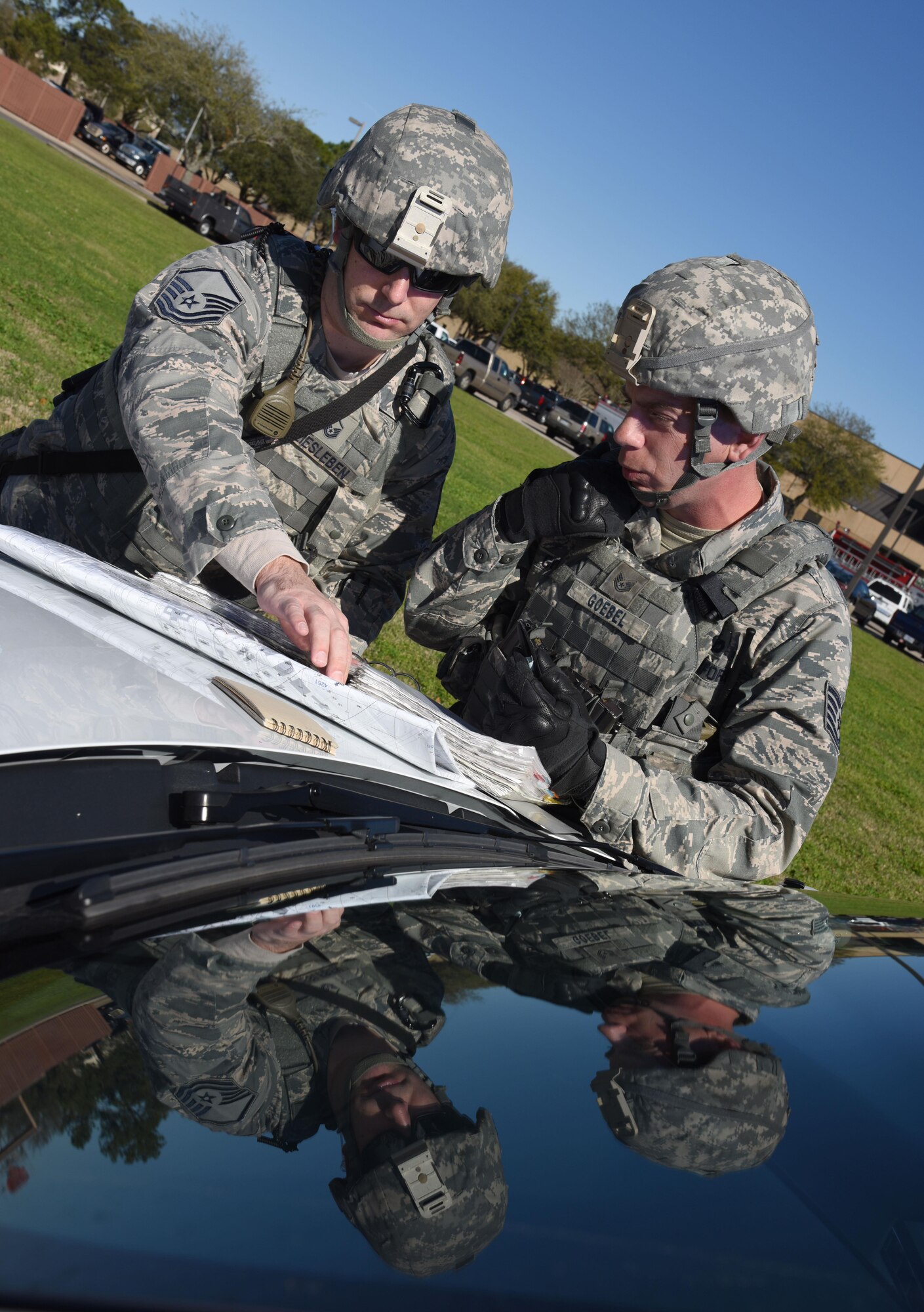 Master Sgt. Joseph Freiesleben, 81st Security Forces Squadron operations superintendent, and Tech. Sgt. Eric Goebel, 81st SFS flight chief, discuss a cordon perimeter during a train derailment exercise Feb. 16, 2017, on Keesler Air Force Base, Miss. The exercise scenario simulated a train and vehicle collision, which resulted in a derailment and chemical spill, creating a mass casualty and HAZMAT response event. This exercise tested base and local civilian emergency response organizations’ ability to operate in a multi-agency and multi-jurisdiction crisis situation. (U.S. Air Force photo by Kemberly Groue)