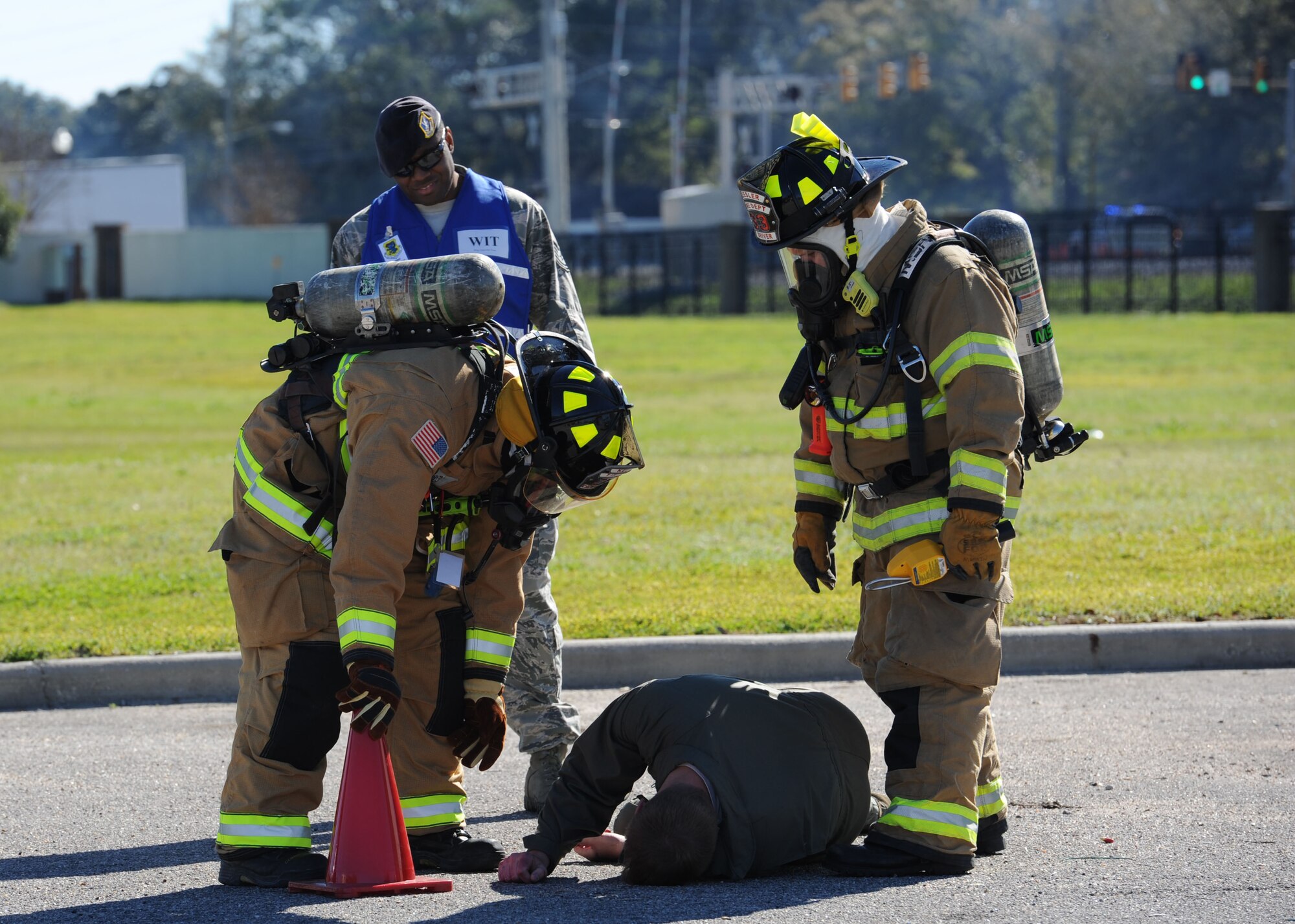 Firefighters from the 81st Infrastructure Division assist a “victim” during a train derailment exercise Feb. 16, 2017, on Keesler Air Force Base, Miss. The exercise scenario simulated a train and vehicle collision, which resulted in a derailment and chemical spill, creating a mass casualty and HAZMAT response event. This exercise tested base and local civilian emergency response organizations’ ability to operate in a multi-agency and multi-jurisdiction crisis situation. (U.S. Air Force photo by Kemberly Groue)