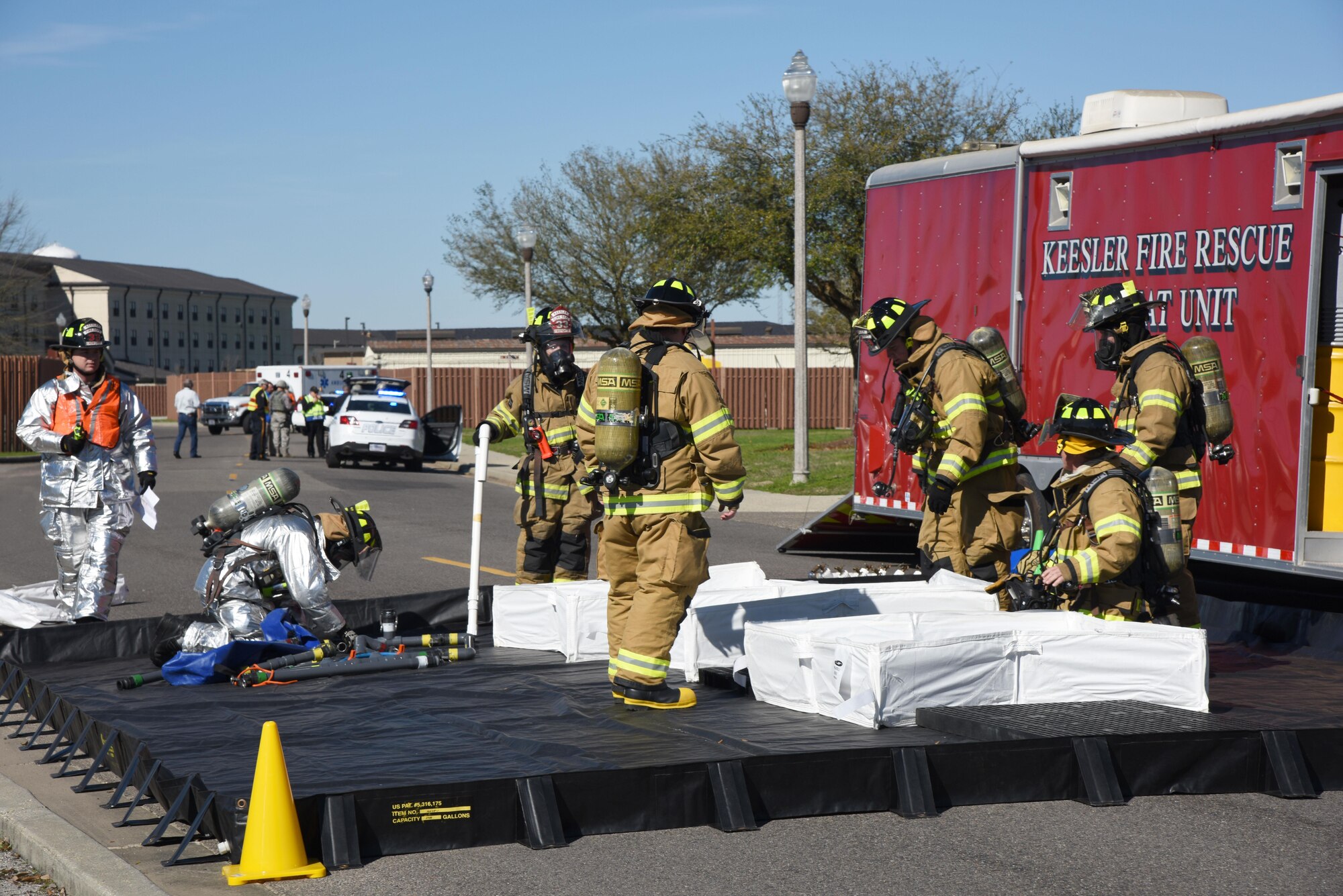 Members of the 81st Infrastructure Division fire department set up a decontamination site for affected “victims” during a train derailment exercise Feb. 16, 2017, on Keesler Air Force Base, Miss. The exercise scenario simulated a train and vehicle collision, which resulted in a derailment and chemical spill, creating a mass casualty and HAZMAT response event. This exercise tested base and local civilian emergency response organizations’ ability to operate in a multi-agency and multi-jurisdiction crisis situation. (U.S. Air Force photo by Kemberly Groue)