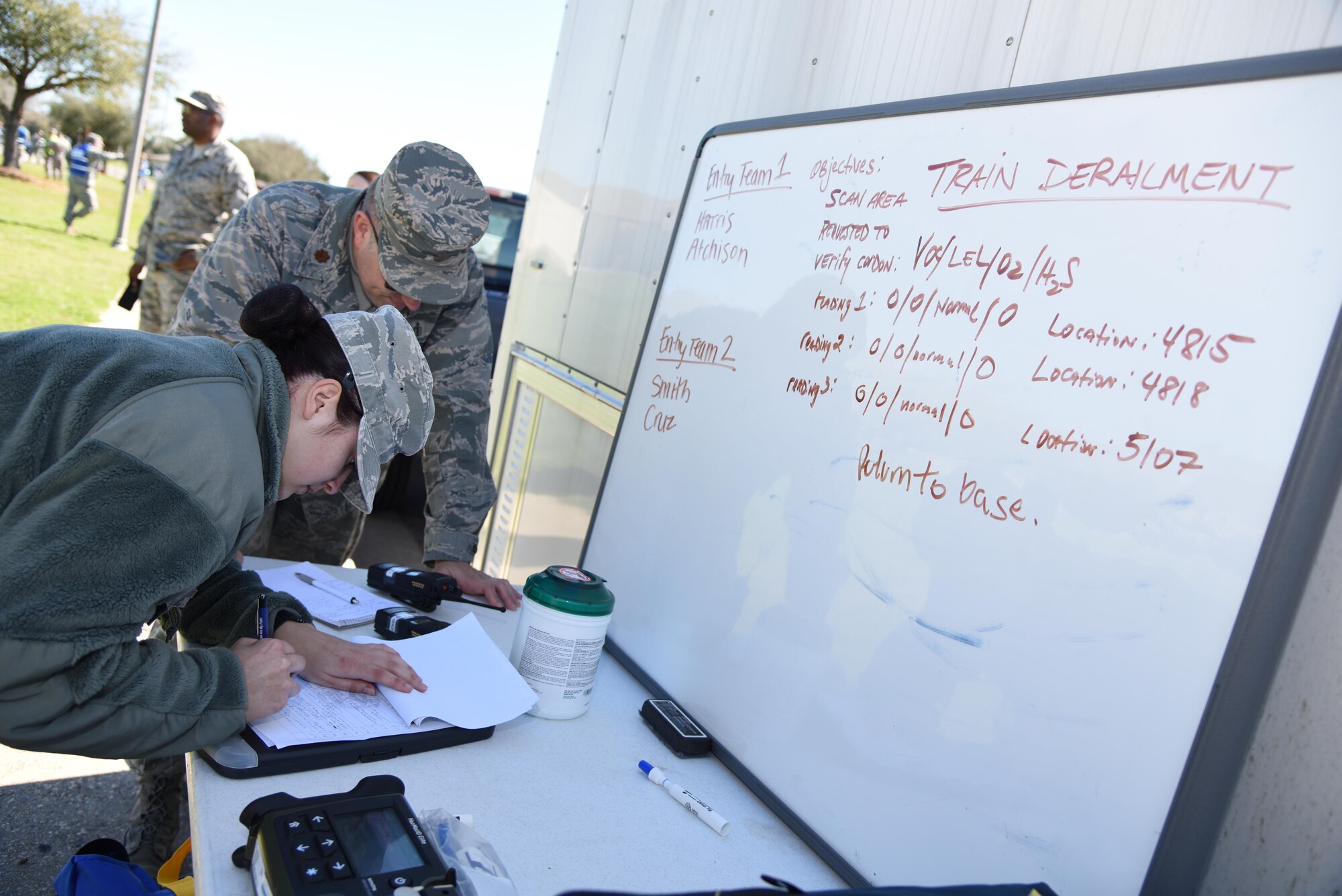 Maj. Daniel Schneider, 81st Aerospace Medicine Squadron bioengineering flight commander, and Senior Airman Tori Smith, 81st AMDS bioenvironmental technician, document perimeter readings during a train derailment exercise Feb. 16, 2017, on Keesler Air Force Base, Miss. The exercise scenario simulated a train and vehicle collision, which resulted in a derailment and chemical spill, creating a mass casualty and HAZMAT response event. This exercise tested base and local civilian emergency response organizations’ ability to operate in a multi-agency and multi-jurisdiction crisis situation. (U.S. Air Force photo by Kemberly Groue)