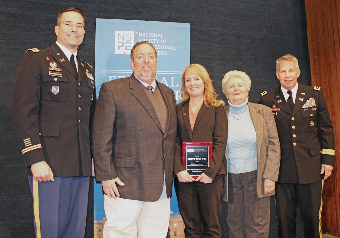 Mary Foutz, U.S. Army Corps of Engineers, Baltimore District Military Design Branch, Mechanical Section chief, holds agency winner award received during the Federal Engineer of the Year Award ceremony at the National Press Club in Washington, D.C., Feb. 17, 2017. Foutz was joined by her husband and mother, as well as Col. Ed Chamberlayne (at left), Baltimore District commander, and Lt. Gen. Todd T. Semonite (at right), chief of Engineers and commanding general of the Corps of Engineers. (U.S. Army photo by Sarah Gross)