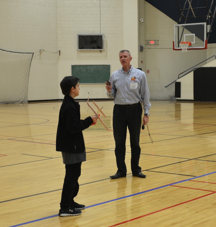 ALBUQUERQUE, N.M. – Wright Stuff event judge Reginald Bourgeois, right, gives last minute instructions to Cottonwood Classical Prep School student Ty Webster, before he launches his plane, Jan. 28, 2017.

