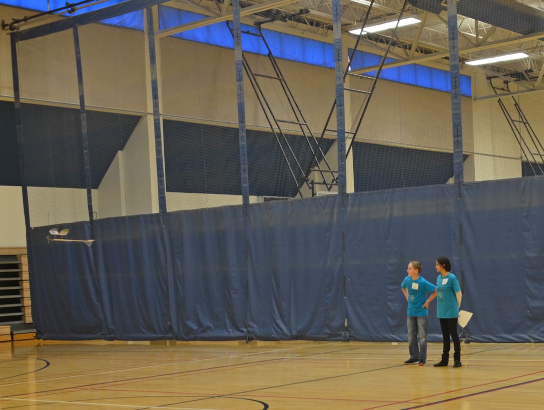 ALBUQUERQUE, N.M. – Steven Johnson and Brianna Ulibarri, both with the Albuquerque Area Homeschoolers, watch their plane as it flies around the gymnasium during the Wright Stuff event, Jan. 28, 2017. 