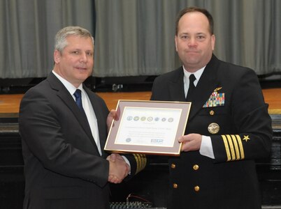 Retired Air Force Lt. Col. Todd Ernst (R) receives The Seven Seals Award from Employer Support of the Guard and Reserve (ESGR) from Navy Capt. Steve Knight (L) during a ceremony on Feb. 13 at Joint Base San Antonio-Randolph, Texas to honor him for his efforts to bring about the legislative change that now ensures families of Reserve and Guard service members receive the same survivor benefits as active duty service members. (Air Force photo by Joel Martinez, Joint Base San Antonio-Randolph Public Affairs)

