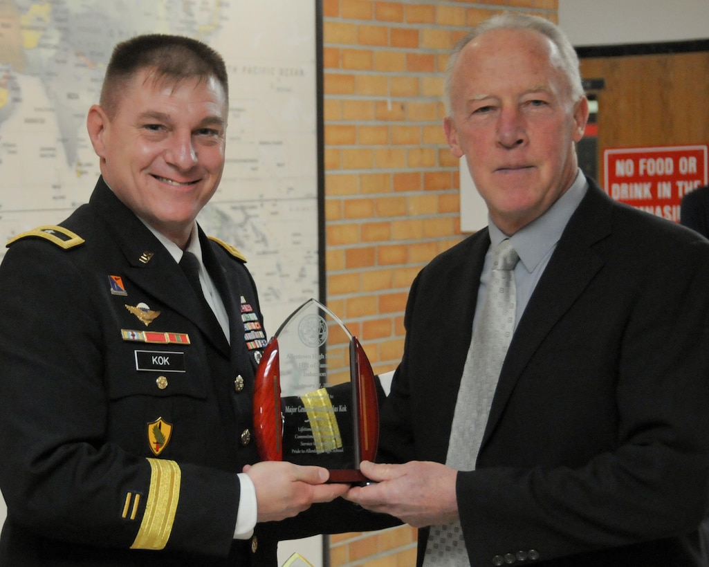 Maj. Gen. Troy D. Kok, commanding general of the U.S. Army Reserve’s 99th Regional Support Command, left, is inducted into the Allentown High School Hall of Fame Feb. 17 during a ceremony at the school. Kok was nominated for the school’s hall of fame by his former football and cross-country coach, Doug Hunt, right, who taught at Allentown High School for 39 years.