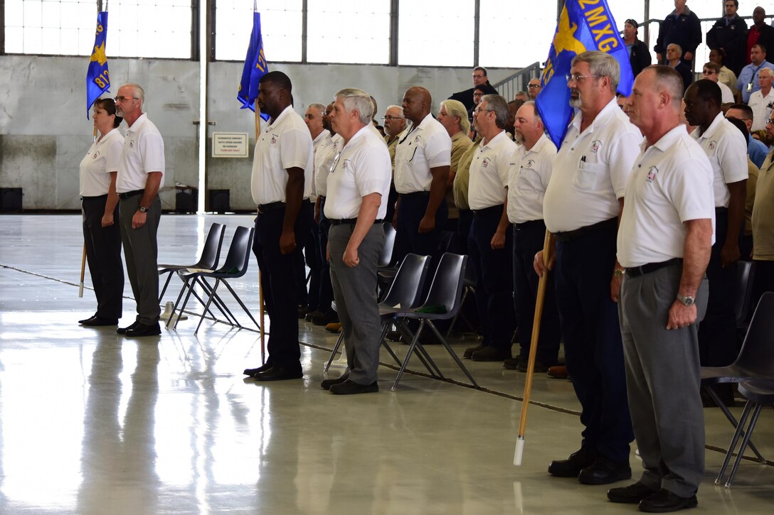 Civilian employees with the newly activated 12th maintenance Group activate the group's three squadrons during a ceremony Feb. 10 at Joint Base San Antonio-Randolph, Texas.  The group is the first civil service maintenance directorate in Air Education and Training Command to reorganize as a group.  (U.S. Air Force photo by Randy Martin) 