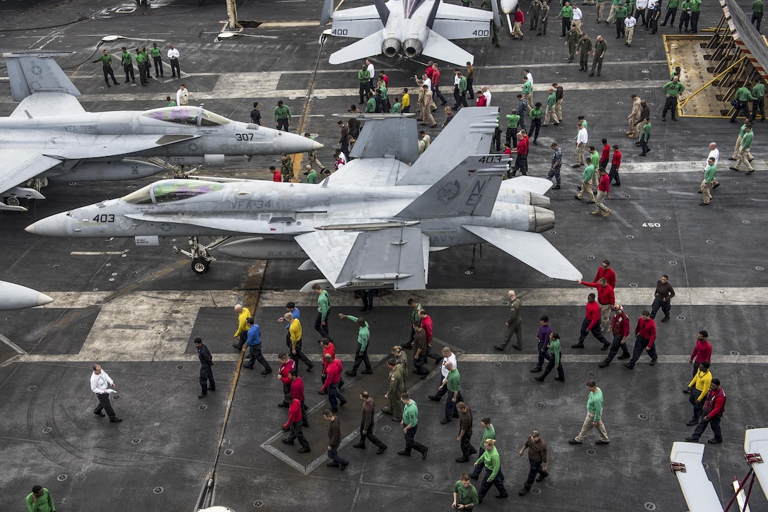 Sailors look for foreign objects on the flight deck of the USS Carl Vinson in the Philippine Sea, Feb. 16, 2017. The aircraft carrier is operating as part of the U.S. Pacific Fleet-led initiative to extend the command and control functions of U.S. 3rd Fleet. Navy Photo by Petty Officer 3rd Class Matt Brown