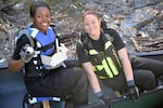 Two Soldiers show off some of the unusual items they retrieved from Salad Creek during the 2017 Basura Bash at Joint base San Antonio-Fort Sam Houston Saturday, Feb. 18.