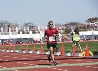 U.S. Navy Petty Officer 2nd Class Luis Amaya, 1st Marine Aircraft Wing hospital corpsman, crosses the finish line of the 25th Annual Okinawa Marathon Feb. 19, 2017, at the Okinawa Prefectural Comprehensive Park in Okinawa, Japan. The Okinawa Marathon is hosted every year and is open to everyone above the age of 16. (U.S. Air Force photo by Senior Airman Omari Bernard/Released)