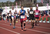 Marathon runners sprint to the finish line of the Okinawa Marathon Feb. 19, 2017, at the Okinawa Prefectural Comprehensive Park in Okinawa, Japan. This year marks the 25th anniversary of the Okinawa Marathon and the 25th year that Kadena AB has supported the race. (U.S. Air Force photo by Senior Airman Omari Bernard/Released)