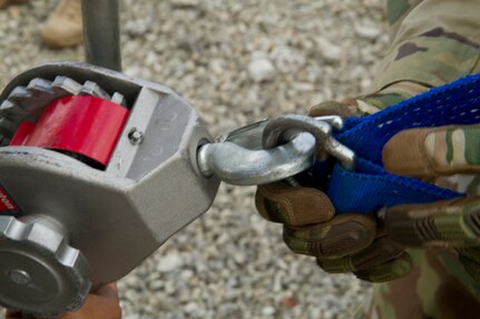 Army Reserve Soldiers assigned to the 329th Chemical, Biological, Radiological, and Nuclear (CBRN) Company (Reconnaissance and Surveillance) learn to use a common firefighter tool called a “Come Along” to move a large metal structure during training with the Miami-Dade Fire Rescue Department (MDFR) at the MDFR training facility in Doral, Fla., on Feb. 17, 2017. The Come Along is a hand-operated tool used for dragging or lifting heavy objects. The 329th CBRN Company, from Orlando, Fla., the Army Reserve’s 469th Ground Ambulance Company, from Wichita, Kan., and the Florida National Guard’s Civil Support Team, spent the day training with MDFR firefighters and learned about tools that the Soldiers could use if called up to support hazardous material operations in Port of Miami and Dade County. (Army Reserve Photo by Master Sgt. Mark Bell / Released)