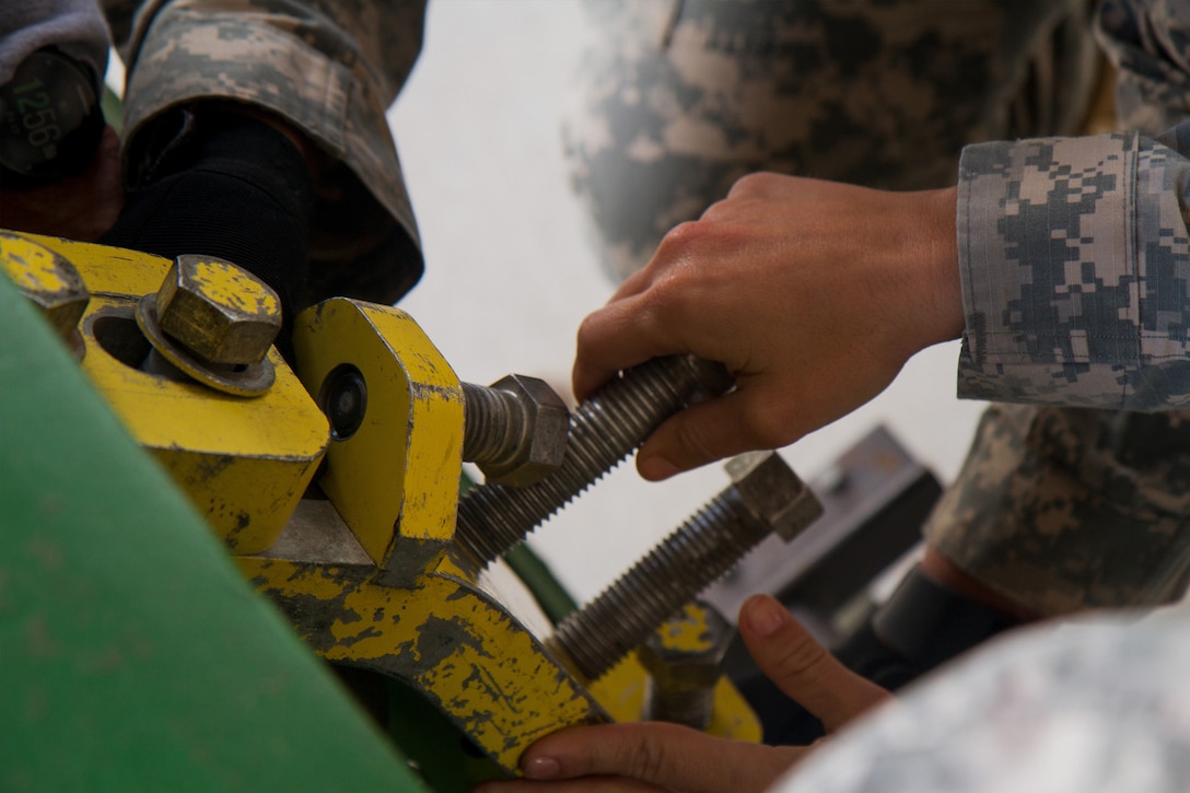 Army Reserve Soldiers assigned to the 329th Chemical, Biological, Radiological, and Nuclear (CBRN) Company (Reconnaissance and Surveillance), use a one-ton cylinder leak kit during joint training at the Miami-Dade Fire Rescue Department (MDFR) training facility on Feb. 17, 2017 in Doral, Fla. The 329th CBRN Company, from Orlando, Fla., the Army Reserve’s 469th Ground Ambulance Company, from Wichita, Kan., and the Florida National Guard’s Civil Support Team, spent the day training with MDFR firefighters and learned about tools Soldiers could use if called up to support hazardous material operations in Port of Miami and Dade county. (Army Reserve photo by Master Sgt. Mark Bell / Released)