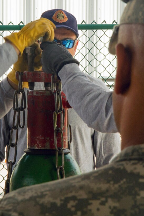 Lt. Christopher Pecori, a flight medic with the Miami-Dade Fire Rescue Department (MDFR), demonstrates on how to cap a gas cylinder to Army Reserve Soldiers during training at the MDFR training facility on Feb. 17, 2017 in Doral, Fla. The Soldiers are assigned to the 329th Chemical, Biological, Radiological, and Nuclear (CBRN) Company (Reconnaissance and Surveillance), based in Orlando, Fla. The 329th CBRN Company, the Army Reserve’s 469th Ground Ambulance Company, from Wichita, Kan., and the Florida National Guard’s Civil Support Team, spent the day training with MDFR firefighters and learned about tools Soldiers could use if called up to support hazardous material operations in Port of Miami and Dade County. (Army Reserve Photo by Master Sgt. Mark Bell / Released)