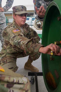 Army Reserve Spc. Angelica Dobrock, who is assigned to the 329th Chemical, Biological, Radiological, and Nuclear (CBRN) Company (Reconnaissance and Surveillance), caps a leak by bolting down cap on one-ton gas cylinder during training with the Miami-Dade Fire Rescue Department (MDFR) training facility in Doral, Fla., on Feb. 17, 2017. Dobrock, who has been in the Army Reserve eight years, is a CBRN specialist from Lake Wales, Fla. The 329th CBRN Company, from Orlando, Fla., the Army Reserve’s 469th Ground Ambulance Company, from Wichita, Kan., and the Florida National Guard’s Civil Support Team, spent the day training with MDFR firefighters and learned about tools Soldiers could use if called up to support hazardous material operations in Port of Miami and Dade County. (Army Reserve photo by Master Sgt. Mark Bell / Released)