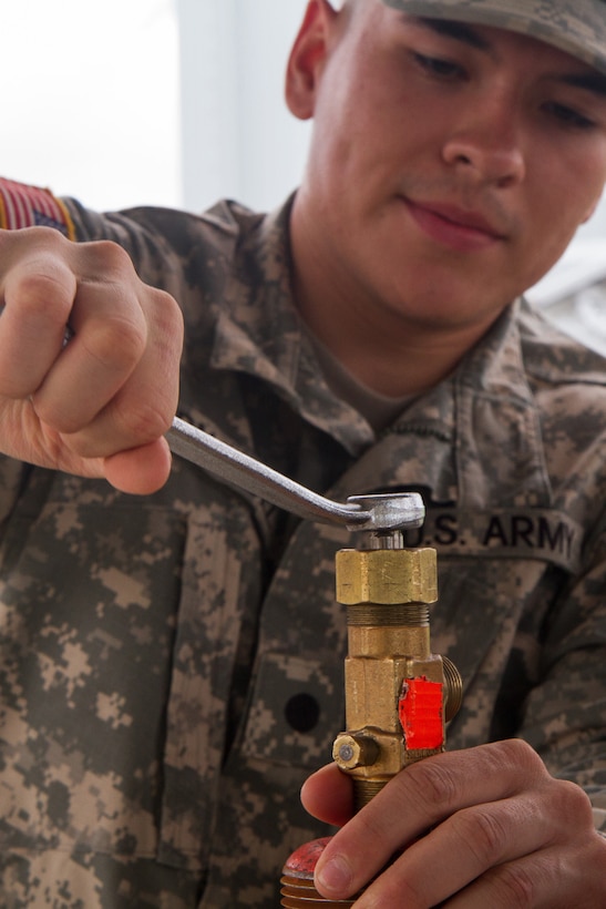 Army Reserve Cadet Peter Hernandez, who is assigned to the 329th Chemical, Biological, Radiological, and Nuclear (CBRN) Company (Reconnaissance and Surveillance), tightens the stem on a gas cylinder during training with the Miami-Dade Fire Rescue Department (MDFR) at the training facility in Doral, Fla., on Feb. 17, 2017. Hernandez, 20, is from Orlando, Fla. The 329th CBRN Company, from Orlando, the Army Reserve’s 469th Ground Ambulance Company, from Wichita, Kan., and the Florida National Guard’s Civil Support Team, spent the day training with MDFR  firefighters and learned about tools Soldiers could use if called up to support hazardous material operations in Port of Miami and Dade County. (Army Reserve photo by Master Sgt. Mark Bell / Released)