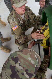 Army Reserve Spc. Angelica Dobrock (top) and Cpl. Shalandis Johnson, who are both assigned to the 329th Chemical, Biological, Radiological, and Nuclear (CBRN) Company (Reconnaissance and Surveillance), caps a leak by bolting down cap on a one-ton gas cylinder during training with the Miami-Dade Fire Rescue Department (MDFR) training facility in Doral, Fla., on Feb. 17, 2017. Dobrock, who has been in the Army Reserve eight years, is a CBRN specialist from Lake Wales, Fla., and Johnson is a  CBRN specialist from Orlando, Fla. The 329th CBRN Company, from Orlando, the Army Reserve’s 469th Ground Ambulance Company, from Wichita, Kan., and the Florida National Guard’s Civil Support Team, spent the day training with MDFR firefighters and learned about tools Soldiers could used if called up to support hazardous material operations in Port of Miami and Dade County. (Army Reserve photo by Master Sgt. Mark Bell / Released)