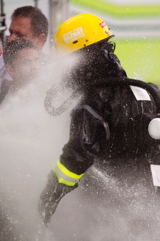 Firefighter David Guerra, a flight medic with the Miami-Dade Fire Rescue Department (MDFR), begins the decontamination process at the Port of Miami during a joint hazard material exercise with the Army Reserve’s 329th Chemical, Biological, Radiological, and Nuclear (CBRN) Company (Reconnaissance and Surveillance) on Feb. 18, 2017 in Miami, Fla. The 329th CBRN Company, from Orlando, Fla., the Army Reserve’s 469th Ground Ambulance Company, from Wichita, Kan., and the Florida National Guard’s Civil Support Team, spent the day training with MDFR firefighters during a sustainment training exercise that combines civil authorities and Defense CBRN Response Force. The Miami event was the second training exercise of its kind for Northern Command. The first exercise held with a municipality was in New York City. The 329th CBRN Company is the only chemical company on the DCRF. The DCRF mission is to save lives, mitigate human suffering and facilitate recovery operations in a CBRN environment. The DCRF consists of 5,200 personnel to include Soldiers, Sailors, Airmen, Marines and civilians from active-duty and reserve component units. The DCRF is a scalable force that is part of a larger collaborative response capability between local, state, tribal and federal agencies. DCRF assets are used to support the primary agency in the event of a CBRN incident. (Army Reserve photo by Master Sgt. Mark Bell / Released)