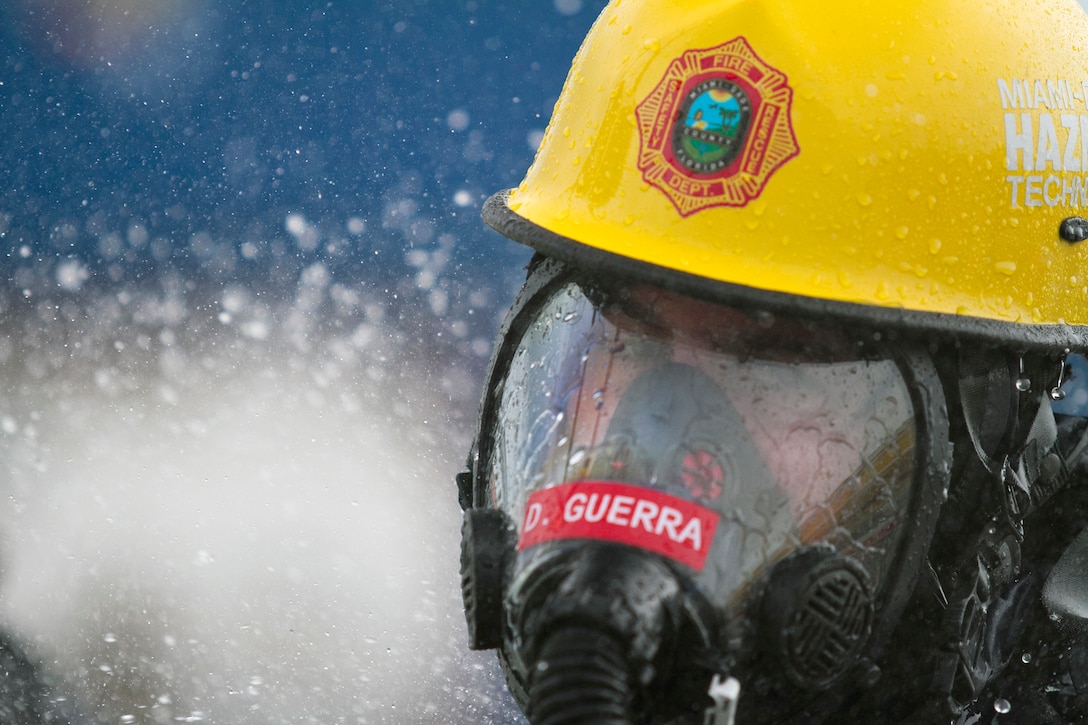 Firefighter David Guerra, a flight medic with the Miami-Dade Fire Rescue Department (MDFR), begins the decontamination process at the Port of Miami during a joint hazard material exercise with the Army Reserve’s 329th Chemical, Biological, Radiological, and Nuclear (CBRN) Company (Reconnaissance and Surveillance) on Feb. 18, 2017 in Miami, Fla. The 329th CBRN Company, from Orlando, Fla., the Army Reserve’s 469th Ground Ambulance Company, from Wichita, Kan., and the Florida National Guard’s Civil Support Team, spent the day training with MDFR firefighters during a sustainment training exercise that combines civil authorities and Defense CBRN Response Force. The Miami event was the second training exercise of its kind for Northern Command. The first exercise held with a municipality was in New York City. The 329th CBRN Company is the only chemical company on the DCRF. The DCRF mission is to save lives, mitigate human suffering and facilitate recovery operations in a CBRN environment. The DCRF consists of 5,200 personnel to include Soldiers, Sailors, Airmen, Marines and civilians from active-duty and reserve component units. The DCRF is a scalable force that is part of a larger collaborative response capability between local, state, tribal and federal agencies. DCRF assets are used to support the primary agency in the event of a CBRN incident. (Army Reserve photo by Master Sgt. Mark Bell / Released)