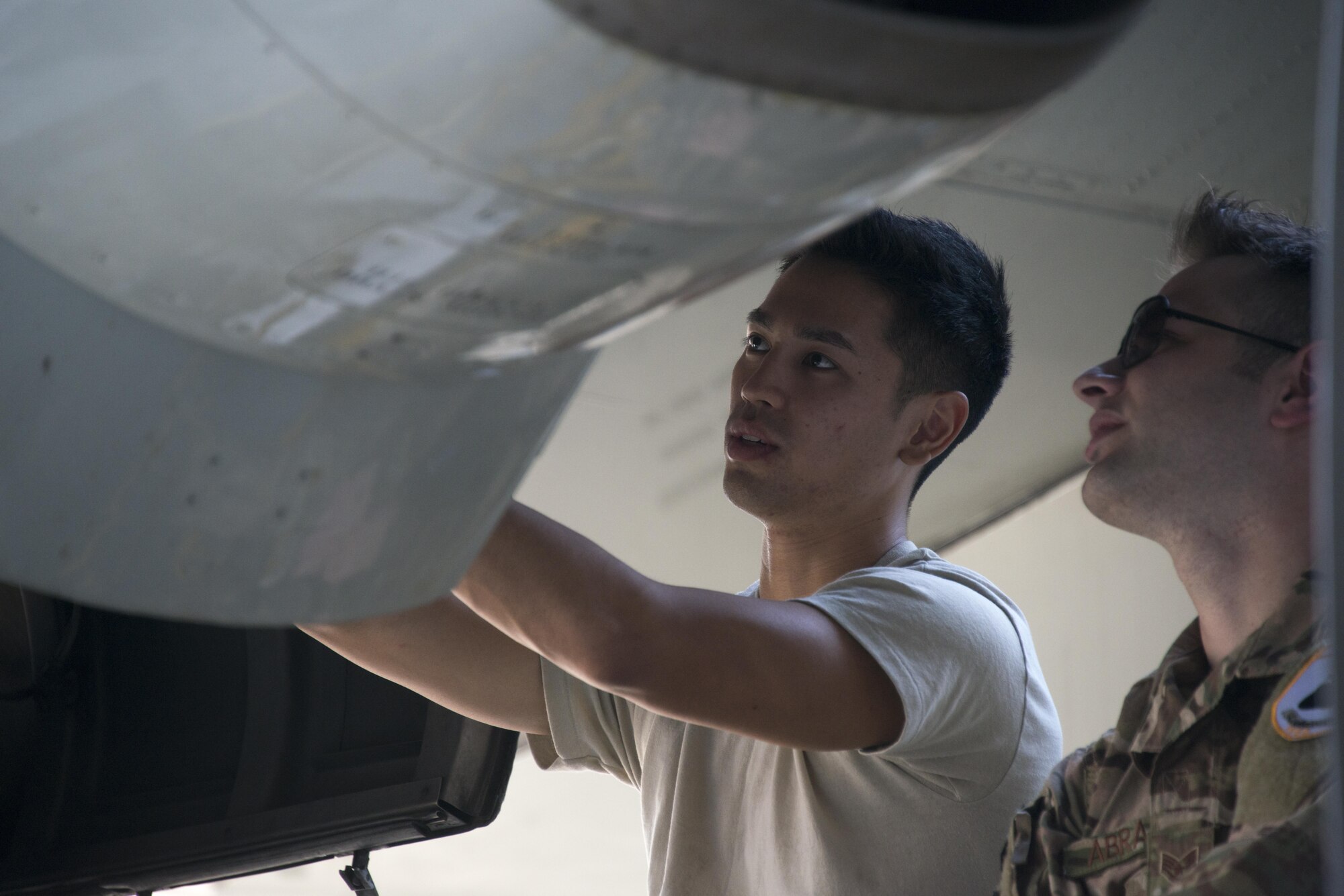 U.S. Air Force Staff Sgts. Dylan Daguay, 353rd Special Operations Maintenance Squadron electro-environmental systems craftsman and Seth Abramson, 353rd SOMXS fuel systems craftsman, remove a wire harness from a Royal Thai Air Force C-130 assigned to the 601st Squadron, Feb. 8, 2017 at Don Mueang Air Base. Leading up to Cobra Gold 2017, members of the 353rd Special Operations Maintenance Squadron conducted an exchange with their RTAF counterparts, Feb. 6-9, 2017 (U.S. Air Force photo by Capt. Jessica Tait)