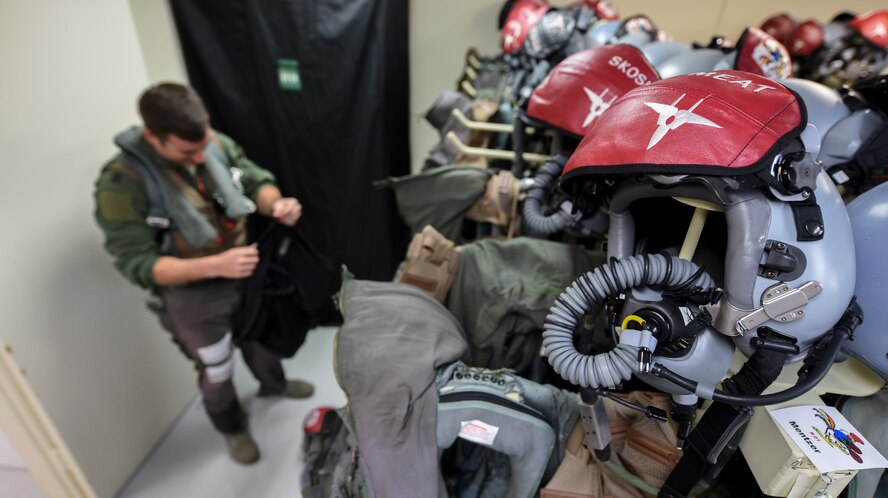 U.S. Air Force Capt. Lance Coldren, 67th Fighter Squadron F-15 Eagle pilot, dons aircrew flight equipment during annual exercise Cope North Feb. 20, 2017, at Andersen Air Force Base, Guam. The 67th FS, from Kadena Air Base, Japan, is conducting a series of flight operations with other units from U.S. Pacific Command, Japan and Australian air forces to increase interoperability and readiness within the theater. (U.S. Air Force photo by Senior Airman John Linzmeier/released)