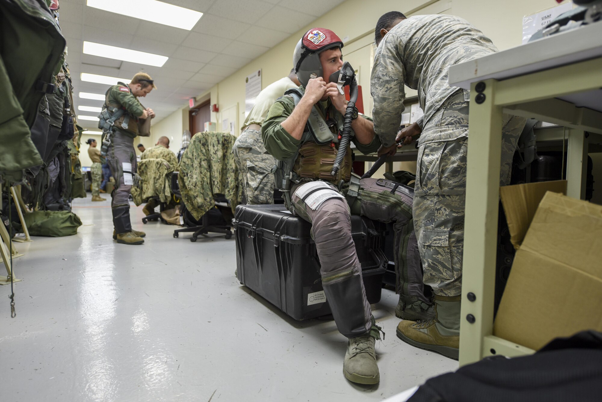 U.S. Air Force Capt. Lance Coldren, 67th Fighter Squadron F-15 Eagle pilot, tests an oxygen mask with an aircrew flight equipment technician from the 18th Operations Support Squadron during annual exercise Cope North Feb. 20, 2017, at Andersen Air Force Base, Guam. Aircrew flight equipment Airmen conduct a series of tests and checks on equipment before every mission, to include checking the airflow of masks, oxygen levels and ensuring headsets are working properly. (U.S. Air Force photo by Senior Airman John Linzmeier/released)