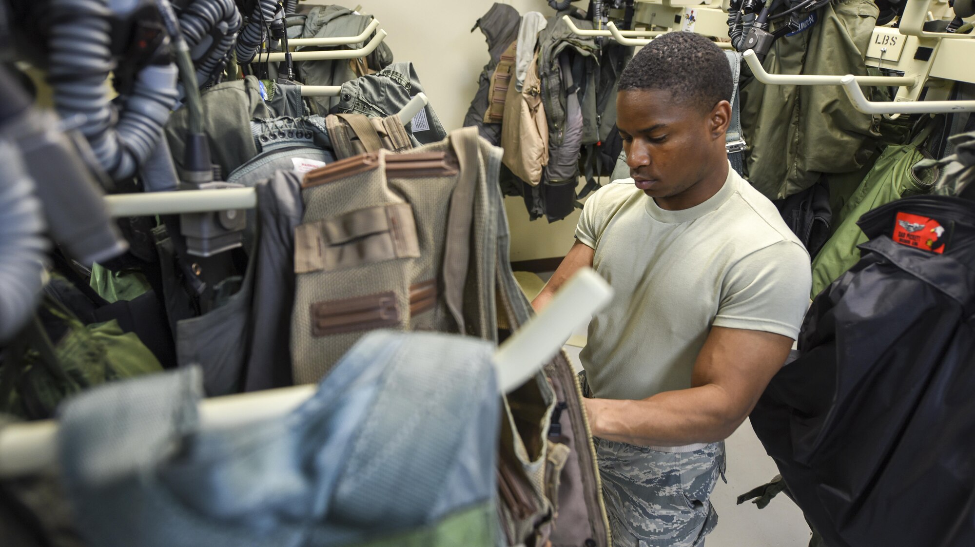 U.S. Air Force Airman Rashad Kelley, 18th Operations Support Squadron aircrew flight equipment technician, prepares flight equipment for use Feb. 20, 2017, at Andersen Air Force Base, Guam. Kelley and other 18th OSS Airmen traveled with the 67th Fighter Squadron from Kadena Air Base, Japan, to participate in Cope North, an annual exercise designed to increase interoperability between the U.S, Japan and Australian air forces. Aircrew flight equipment Airmen support aircrew members from various airframes to aid combat operations. (U.S. Air Force photo by Senior Airman John Linzmeier/released)
