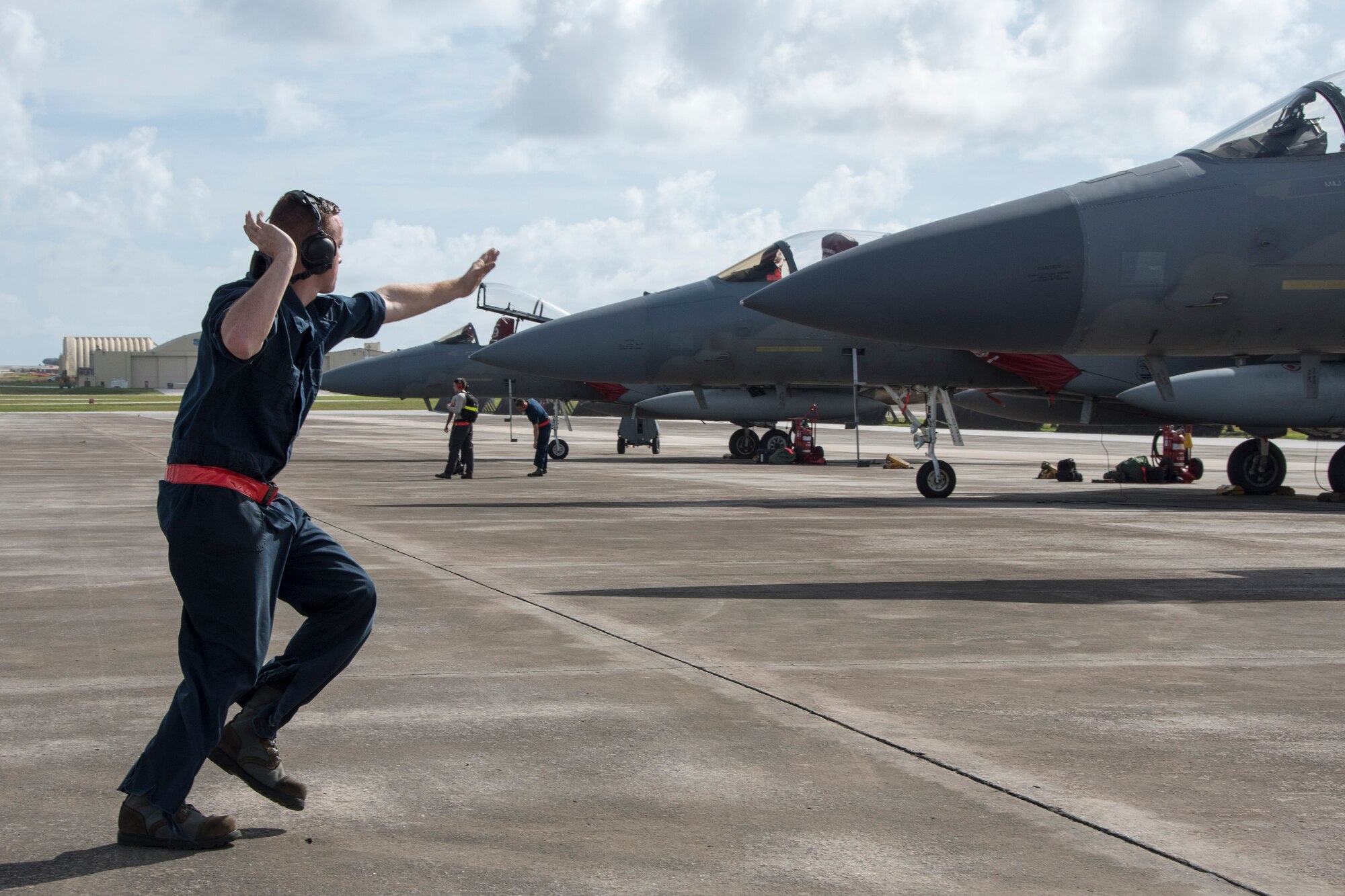 U.S. Air Force Airman 1st Class Dennis Hatcher, 67th Aircraft Maintenance Unit crew chief, marshals an F-15 Eagle, from the 67th Fighter Squadron, to the flightline during annual exercise Cope North Feb. 20, 2017, at Andersen Air Force Base, Guam. Cope North is an annual exercise which serves as a keystone event to promote stability and security throughout the Indo-Asia Pacific by enabling regional forces to hone vital readiness skills. (U.S. Air Force photo by Senior Airman John Linzmeier/released)