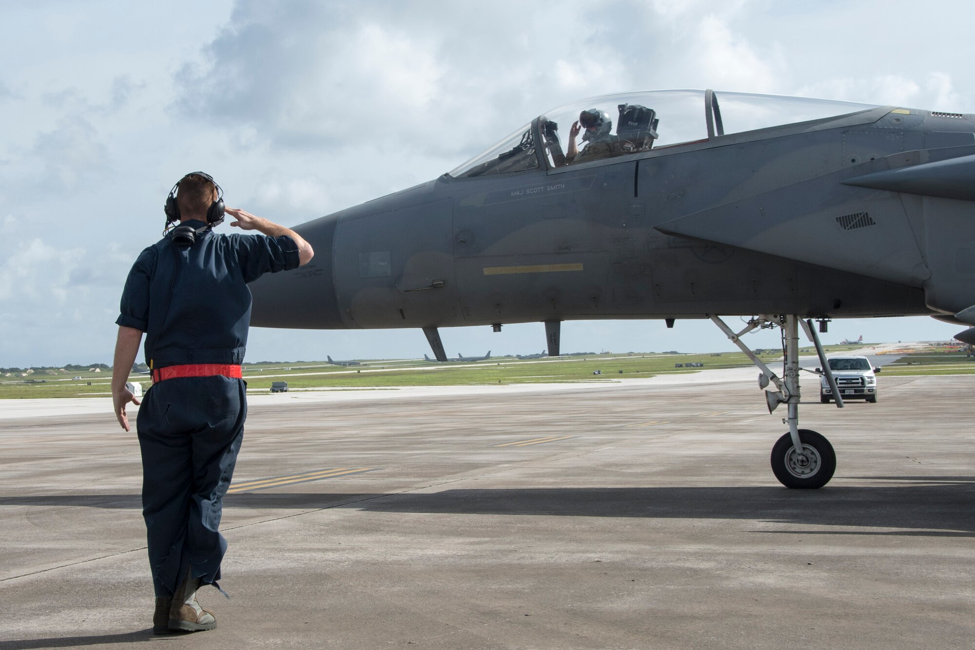 U.S. Air Force Airman 1st Class Dennis Hatcher, 67th Aircraft Maintenance Unit crew chief, salutes an F-15 Eagle pilot from the 67th Fighter Squadron during annual exercise Cope North Feb. 20, 2017, at Andersen Air Force Base, Guam. Aircraft from the 67th FS, and various units from Kadena Air Base, Japan, are training with other Pacific Air Force units and partners from the U.S. Navy and Japan and Australian air forces. (U.S. Air Force photo by Senior Airman John Linzmeier/released)