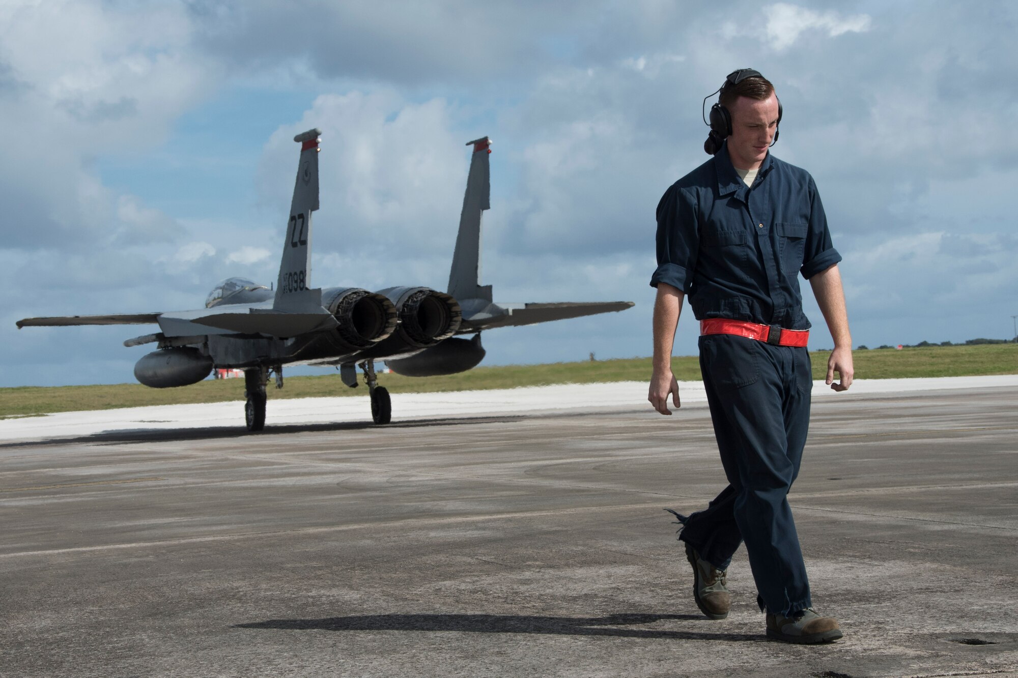 U.S. Air Force Airman 1st Class Dennis Hatcher, 67th Aircraft Maintenance Unit crew chief, steps away from an F-15 Eagle from the 67th Fighter Squadron after marshaling it out to the taxiway during annual exercise Cope North Feb. 20, 2017, at Andersen Air Force Base, Guam. Through training exercises such as Cope North, the U.S., Japan and Australian air forces develop combat capabilities, enhancing air superiority, electronic warfare, air interdiction, tactical airlift and aerial refueling. (U.S. Air Force photo by Senior Airman John Linzmeier/released)