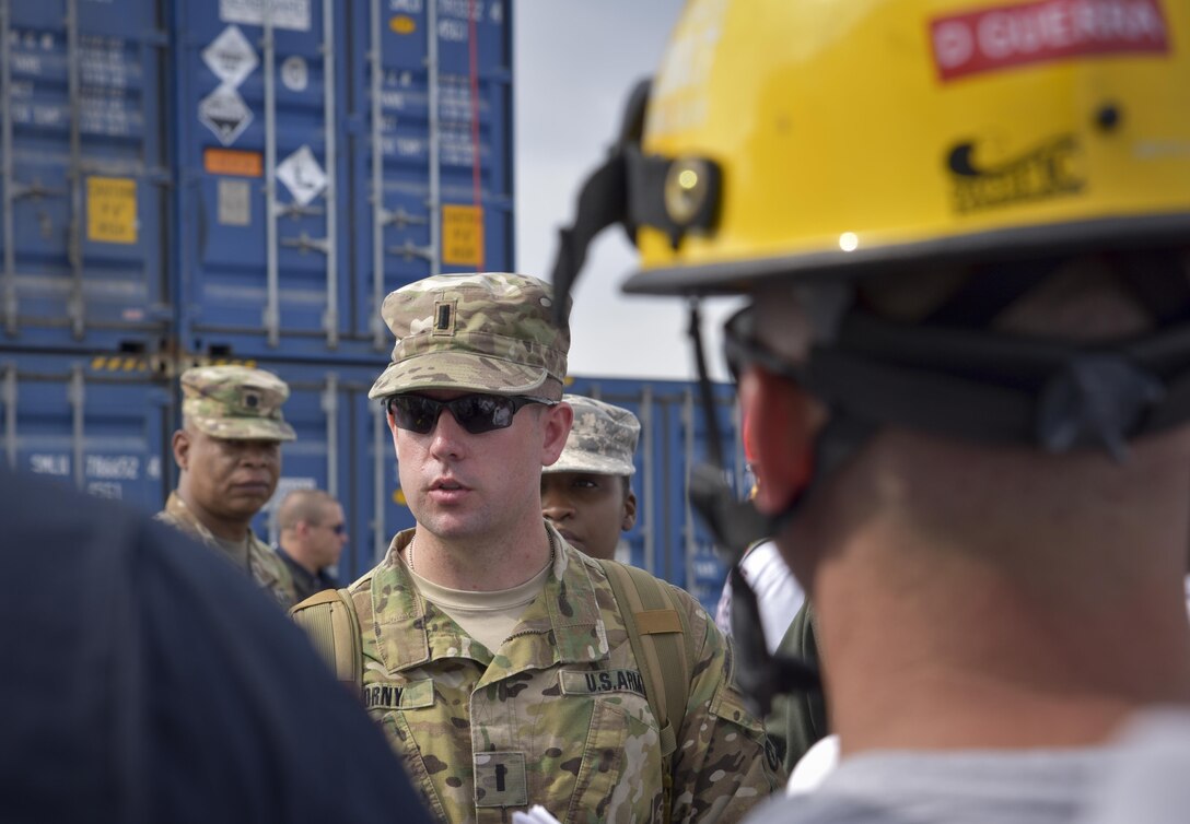 U.S. Army Reserve 1st Lt. Alexander T. Pokorny, a platoon leader with the 329th Chemical Company, receives a safety briefing during a joint hazard material exercise with the U.S. Army and the Miami-Dade Fire Rescue Department (MDFR) at the Port of Miami, Feb. 18, 2017.  The 329th Chemical, Biological, Radiological, and Nuclear (CBRN) Company (Reconnaissance and Surveillance), from Orlando, Fla., the Army Reserve’s 469th Ground Ambulance Company, from Wichita, Kan., and the Florida National Guard’s Civil Support Team, spent the day training with MDFR firefighters during a sustainment training exercise that combines civil authorities and Defense CBRN Response Force, in Miami, Florida. (U.S. Army Reserve photo by Master Sgt. Marisol Walker/Released)