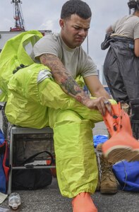 A U.S. Army Reserve Soldier with the 329th Chemical Company based in Orlando, Fla., dons on his Level A personal protective equipment in preparation for a joint hazard material exercise with the U.S. Army and the Miami-Dade Fire Rescue Department at the Port of Miami, Feb. 18, 2017.  The 329th Chemical, Biological, Radiological, and Nuclear (CBRN) Company (Reconnaissance and Surveillance), from Orlando, Fla., the Army Reserve’s 469th Ground Ambulance Company, from Wichita, Kan., and the Florida National Guard’s Civil Support Team, spent the day training with MDFR firefighters during a sustainment training exercise that combines civil authorities and Defense CBRN Response Force, in Miami, Florida. (U.S. Army Reserve photo by Master Sgt. Marisol Walker/Released)