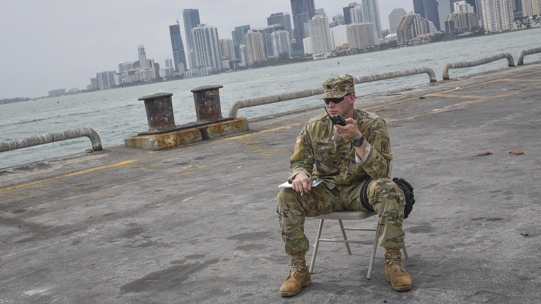 U.S. Army Reserve Sgt. Ryan A. Garvey, a Chemical, Biological, Radiological, and Nuclear specialist with the 329th Chemical Company based in Orlando, Fla., awaits feedback from his team, who were collecting samples during a joint hazard material exercise with the U.S. Army and the Miami-Dade Fire Rescue Department at the Port of Miami, Feb. 18, 2017.  (U.S. Army Reserve photo by Master Sgt. Marisol Walker/Released)