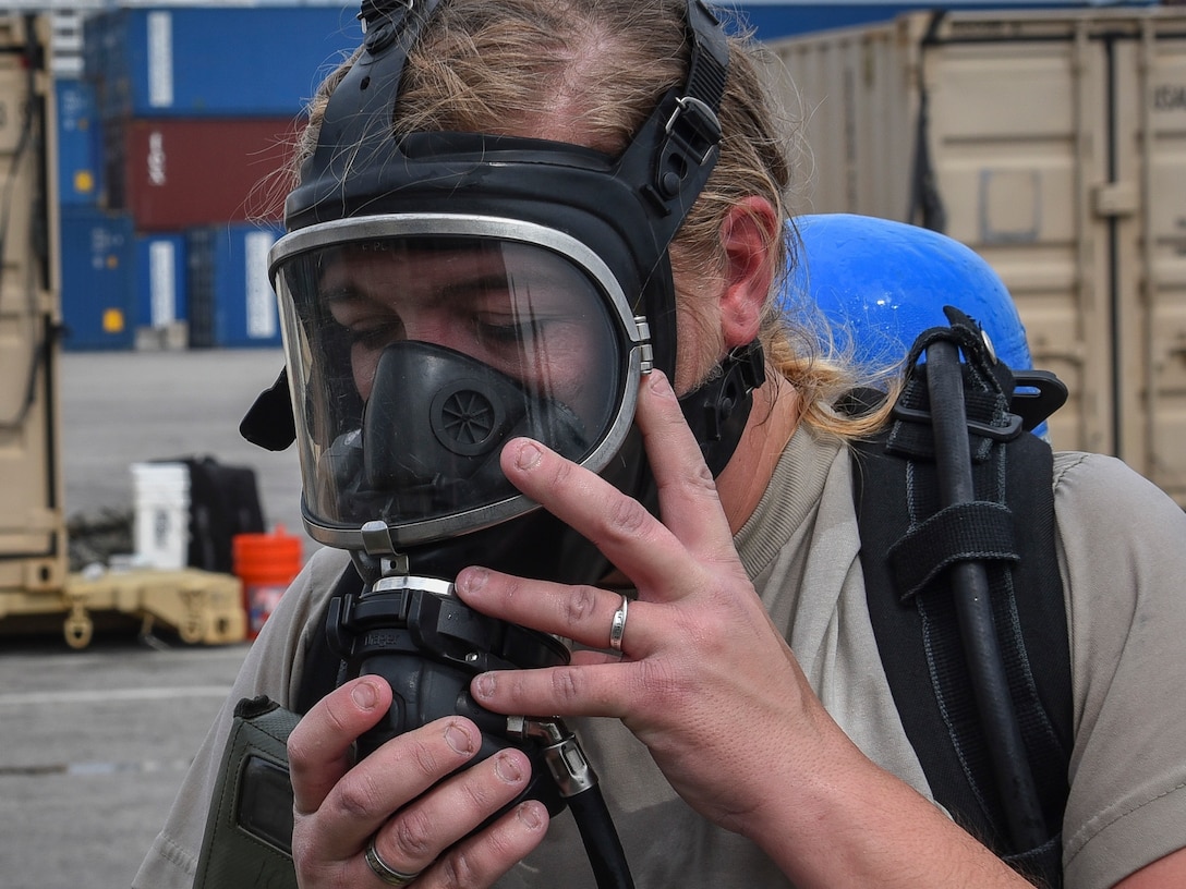 A U.S. Army Reserve Soldier with the 329th Chemical Company based in Orlando, Fla., removes her self-contained breathing apparatus (SCBA) after conducting a joint hazard material exercise with the U.S. Army and the Miami-Dade Fire Rescue Department at the Port of Miami, Feb. 18, 2017.  The 329th Chemical, Biological, Radiological, and Nuclear (CBRN) Company (Reconnaissance and Surveillance), from Orlando, Fla., the Army Reserve’s 469th Ground Ambulance Company, from Wichita, Kan., and the Florida National Guard’s Civil Support Team, spent the day training with MDFR firefighters during a sustainment training exercise that combines civil authorities and Defense CBRN Response Force, in Miami, Florida. (U.S. Army Reserve photo by Master Sgt. Marisol Walker/Released)