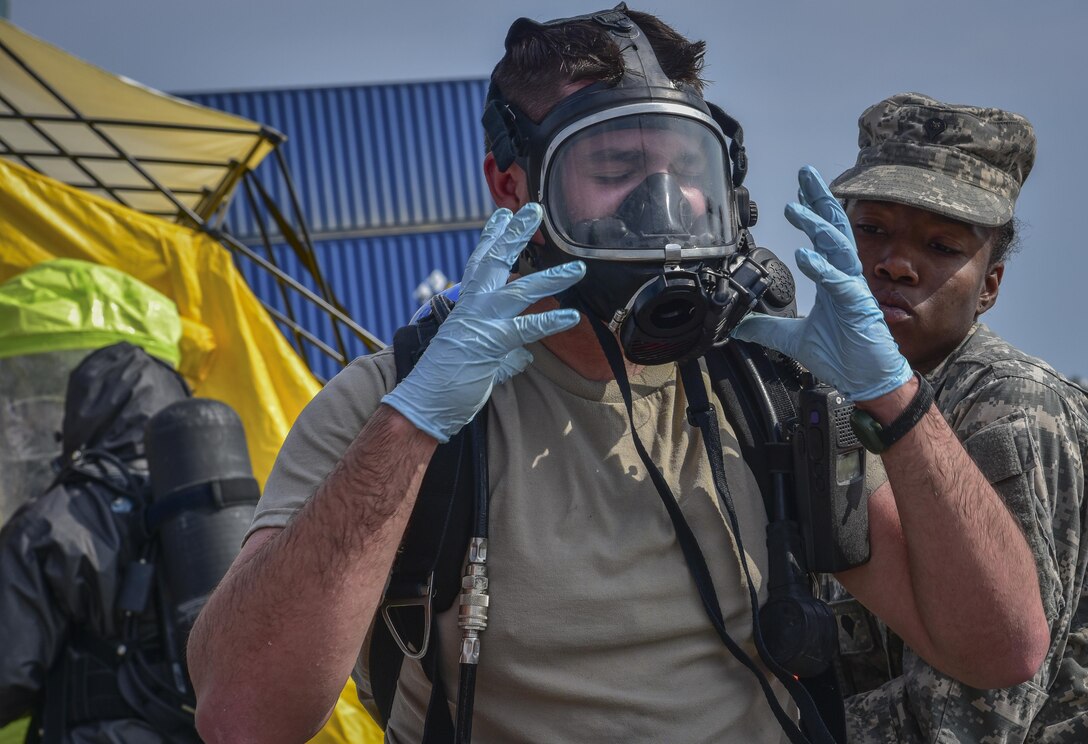 U.S. Army Reserve Sgt. Landon P. Jezek, with the 329th Chemical Company based in Orlando, Fla., removes his self-contained breathing apparatus (SCBA) after conducting a joint hazard material exercise with the U.S. Army and the Miami-Dade Fire Rescue Department at the Port of Miami, Feb. 18, 2017.  The 329th Chemical, Biological, Radiological, and Nuclear (CBRN) Company (Reconnaissance and Surveillance), from Orlando, Fla., the Army Reserve’s 469th Ground Ambulance Company, from Wichita, Kan., and the Florida National Guard’s Civil Support Team, spent the day training with MDFR firefighters during a sustainment training exercise that combines civil authorities and Defense CBRN Response Force, in Miami, Florida. (U.S. Army Reserve photo by Master Sgt. Marisol Walker/Released)